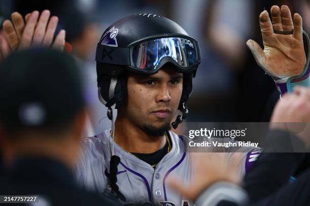 Ezequiel Tovar of the Colorado Rockies celebrates with teammates after after hitting a solo home run in the sixth inning against the Toronto Blue...