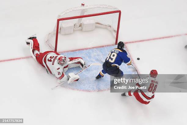 Frederik Andersen and Martin Necas of the Carolina Hurricanes defend the net against Pavel Buchnevich of the St. Louis Blues on April 12, 2024 at the...