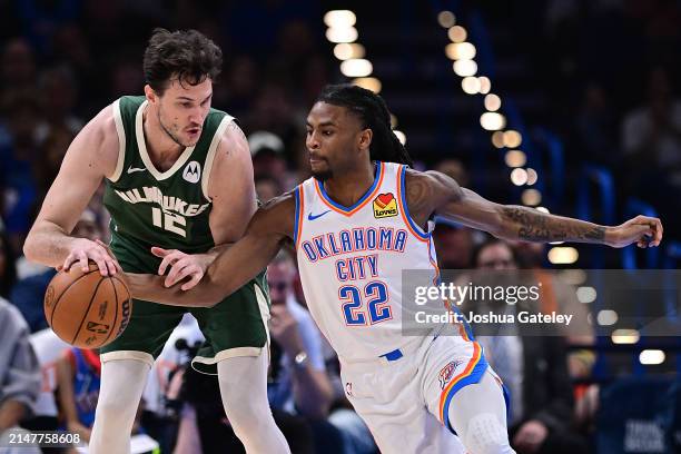 Cason Wallace of the Oklahoma City Thunder reaches in to steal the ball from Danilo Gallinari of the Milwaukee Bucks during the second half at Paycom...