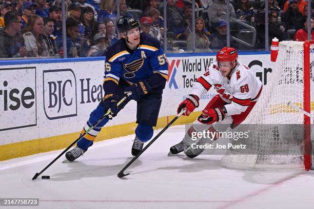 Jake Guentzel of the Carolina Hurricanes pressures Colton Parayko of the St. Louis Blues on April 12, 2024 at the Enterprise Center in St. Louis,...