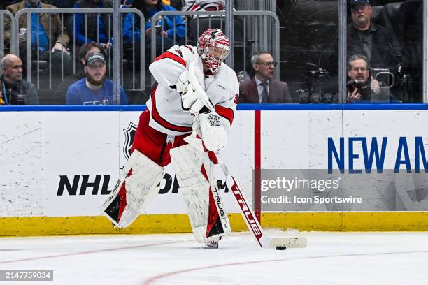 April 12: Carolina Hurricanes goaltender Frederik Andersen plays the puck towards a teammate during a regular season game between the Carolina...