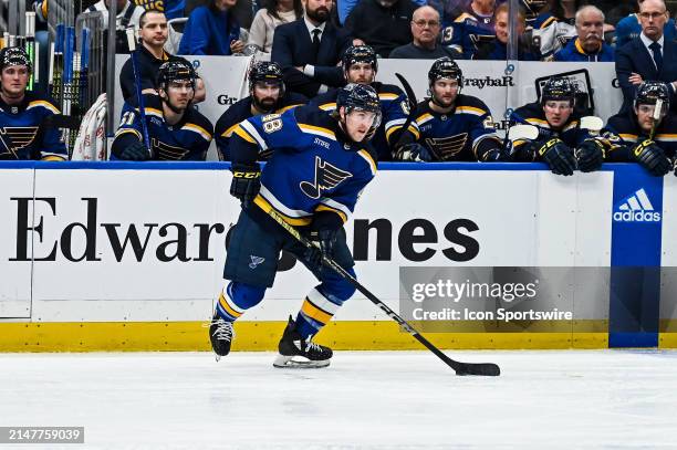 April 12: St. Louis Blues defenseman Scott Perunovich skates the puck out of his own zone during a regular season game between the Carolina...