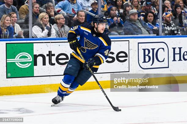 April 12: St. Louis Blues defenseman Scott Perunovich skates with the puck during a regular season game between the Carolina Hurricanes and the St....
