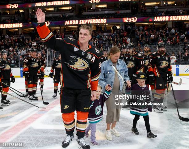 Jakob Silfverberg of the Anaheim Ducks waves to fans with family after his last home game before retiring after their game against the Calgary Flames...