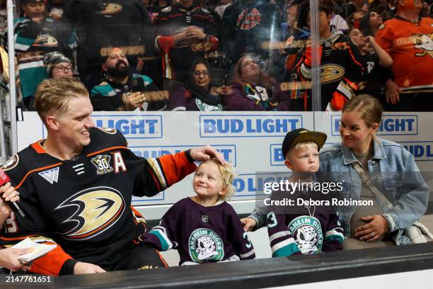 Jakob Silfverberg of the Anaheim Ducks meets with his family after his last home game before retiring after their game against the Calgary Flames at...