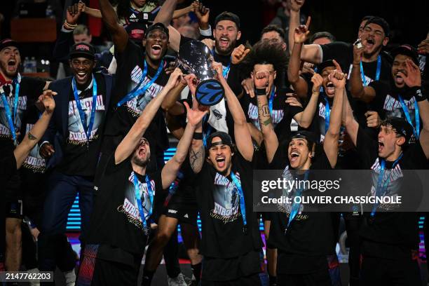 Paris' team celebrates with the trophy on the podium after winning the Eurocup second leg basketball match between JL Bourg and Paris basketball at...