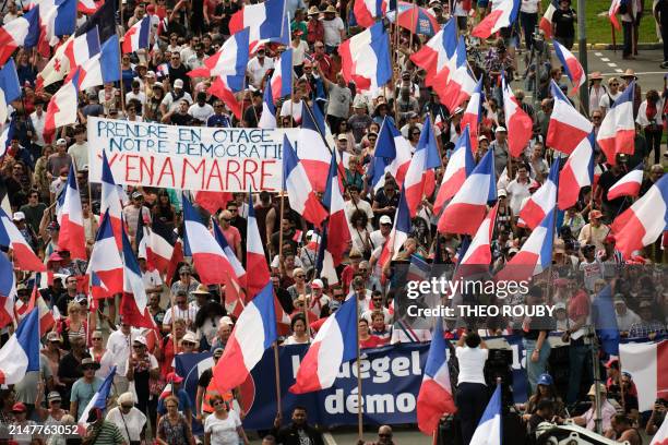 Demonstrators from several loyalist parties wave French national flags and hold a banner reading "Prendre en otage notre democratien y'en a marre" as...
