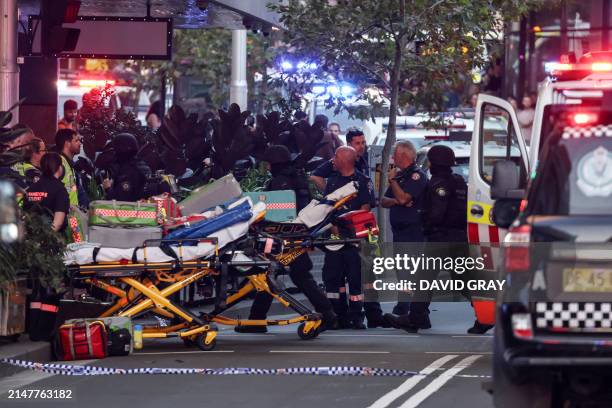 Paramedics push stretchers into the Westfield Bondi Junction shopping mall to retrieve the injured after a stabbing incident in Sydney on April 13,...