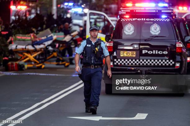 Police officer reacts outside the Westfield Bondi Junction shopping mall after a stabbing incident in Sydney on April 13, 2024. Australian police on...
