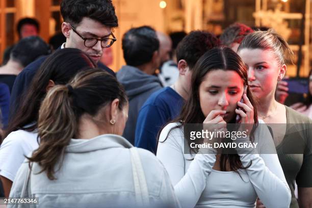 People react outside the Westfield Bondi Junction shopping mall after a stabbing incident in Sydney on April 13, 2024. Australian police on April 13...