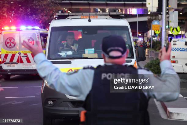 An ambulance leaves the crime site outside the Westfield Bondi Junction shopping mall after a stabbing incident in Sydney on April 13, 2024....