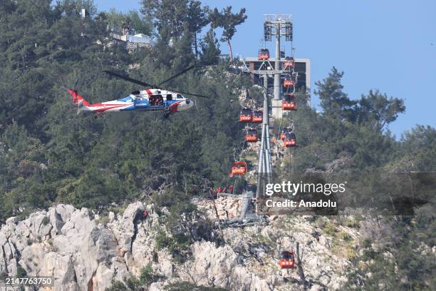 Search and rescue operations continue for the people trapped in the cabins after a cable car cabin crashed into a fallen cable car pole at the...