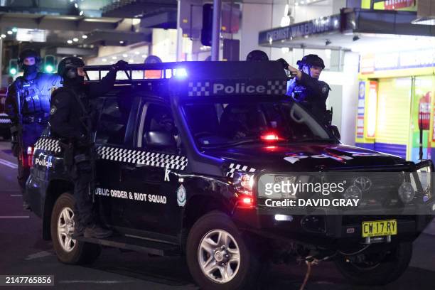 Police patrol in front of the Westfield Bondi Junction shopping mall after a stabbing incident in Sydney on April 13, 2024. The number of people...