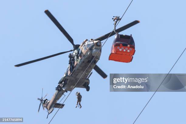 Member of Coast Guard Command participates in evacuation work for the cabins suspended in the air after a cable car cabin crashed into a fallen cable...