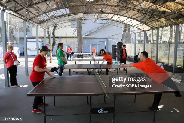 People with special needs play table tennis at Starobazarny Square. Despite the ongoing conflict with Russia, the NGO "Foundation for Special Youth...