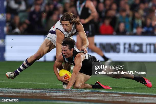 Nat Fyfe of the Dockers tackles Connor Rozee of the Power during the 2024 AFL Round 05 match between the Port Adelaide Power and the Fremantle...