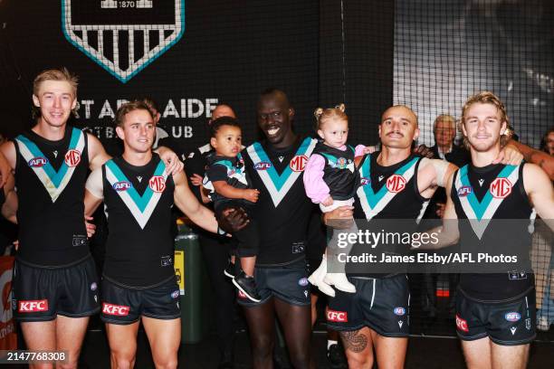 Aliir Aliir and Sam Powell-Pepper of the Power celebrate with their children during the 2024 AFL Round 05 match between the Port Adelaide Power and...