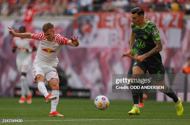 Leipzig's Spanish forward Dani Olmo shoots the ball to score the 1-0 past Wolfsburg's Swiss defender Cedric Zesiger during the German first division...