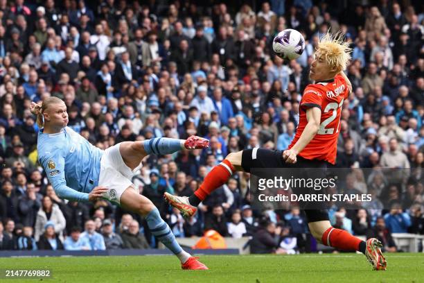 Manchester City's Norwegian striker Erling Haaland sees his shot deflected into the net by Luton Town's Japanese defender Daiki Hashioka for an...