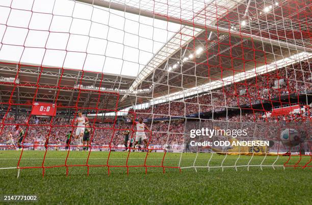 Leipzig's Spanish forward Dani Olmo scores the 1-0 past Wolfsburg's Austrian goalkeeper Pavao Pervan during the German first division Bundesliga...