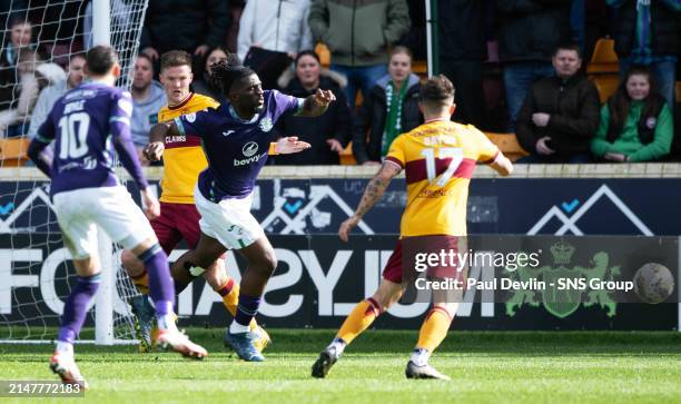 Hbs Rocky Bushiri goes down in the box under a challenge from Motherwell's Blair Spittal during a cinch Premiership match between Motherwell and...