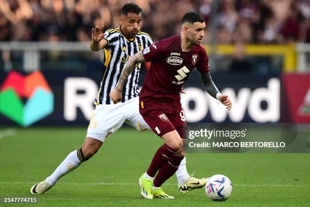 Juventus' Brazilian defender Danilo fights for the ball with Torino's Paraguayan forward Arnaldo Sanabria during the Italian Serie A football match...