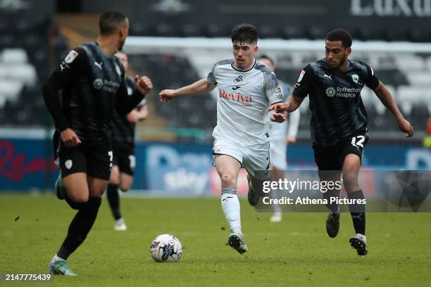 Josh Key of Swansea City is chased by Andy Rinomhota of Rotherham United during the Sky Bet Championship match between Swansea City and Rotherham...