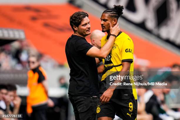 Head Coach Edin Terzic of Borussia Dortmund comforts Sebastien Haller of Borussia Dortmund during the Bundesliga match between Borussia...