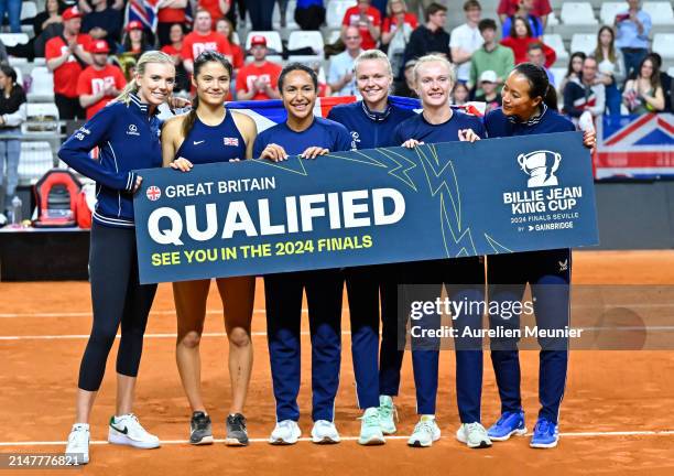 Katie Boulter, Emma Raducanu, Heather Watson, Harriet Dart, Franceska Jones and Captain Anne Keothavong of Great Britain hold a banner reading...