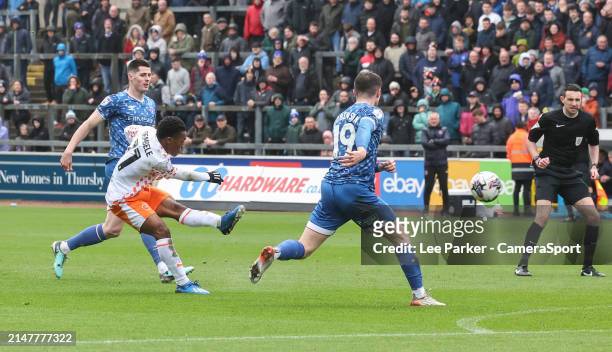 Blackpool's Karamoko Dembele shoots for goal despite the attentions of Carlisle United's Jack Robinson during the Sky Bet League One match between...