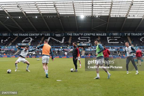 Matt Grimes, Josh Tymon, coach Ryan Harley, Josh Key, Alan Sheehan, assistant head coach and Jay Fulton of Swansea City warm up prior to the game...