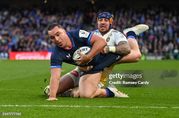 Dublin , Ireland - 13 April 2024; James Lowe of Leinster dives over to score his side's fifth try despite the tackle of Jack Nowell of La Rochelle...