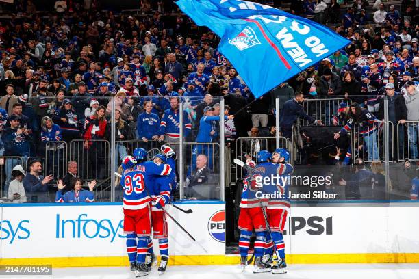 Erik Gustafsson, Mika Zibanejad, Chris Kreider and Vincent Trocheck of the New York Rangers celebrate after a 3-2 shootout win against the New York...
