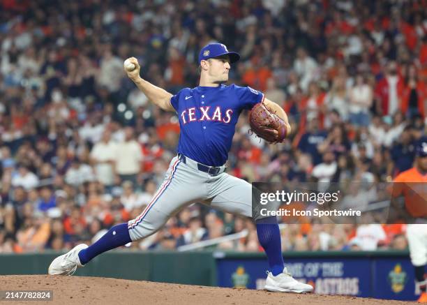 Texas Rangers pitcher David Robertson throws a pitch in the bottom of the eighth inning during the MLB game between the Texas Rangers and Houston...