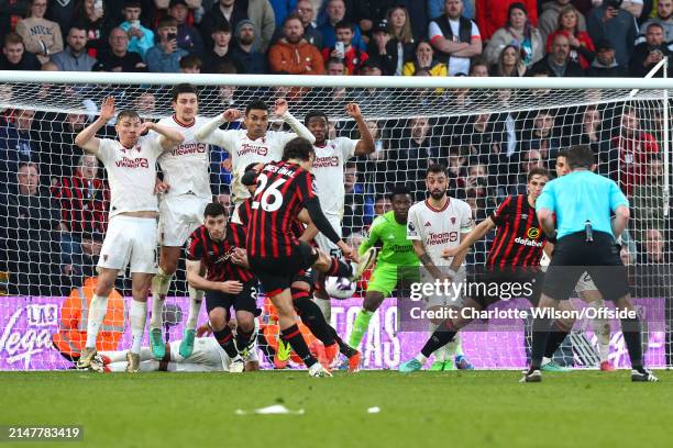 Rasmus Hojlund, Harry Maguire, Casemiro and Willy Kambwala of Manchester United make up the United defensive wall as Enes Unal of Bournemouth takes a...