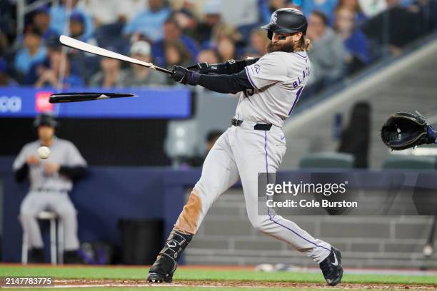 Charlie Blackmon of the Colorado Rockies breaks his bat as he swings in the seventh inning of their MLB game against the Toronto Blue Jays at Rogers...
