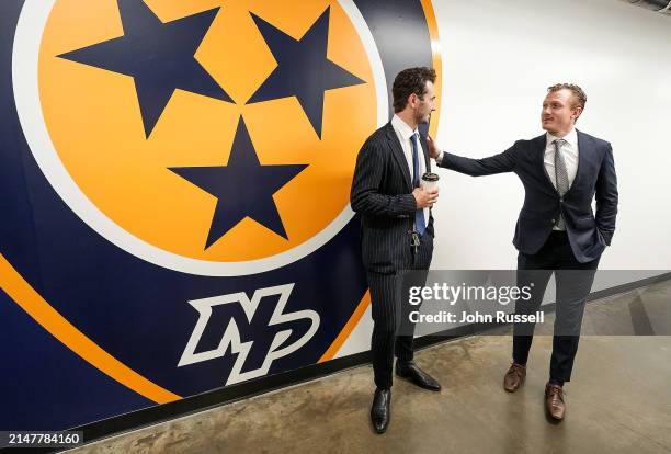 Gustav Nyquist of the Nashville Predators stops to chat with Alexandre Texier of the Columbus Blue Jackets as they arrive for an NHL game at...