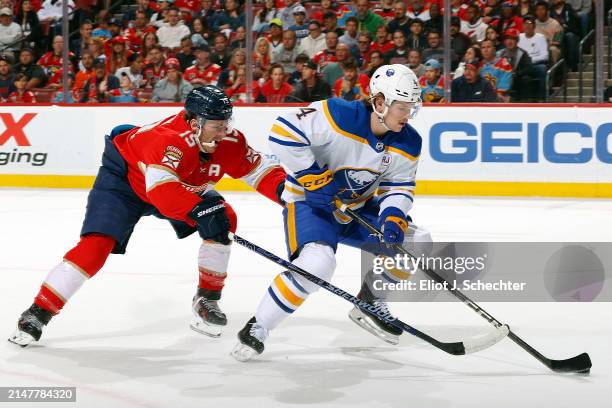 Bowen Byram of the Buffalo Sabres skates with the puck against Matthew Tkachuk of the Florida Panthers at the Amerant Bank Arena on April 13, 2024 in...