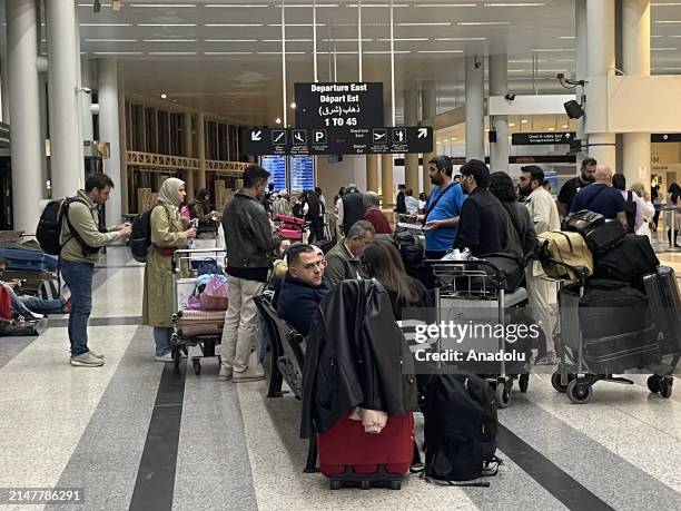 Passengers wait at Beirut Rafic Hariri International Airport as Lebanon closed its airspace to all flight after the Iran's attack on Israel, in...