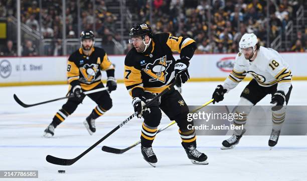 Bryan Rust of the Pittsburgh Penguins skates with the puck in the first period during the game against the Boston Bruins at PPG PAINTS Arena on April...