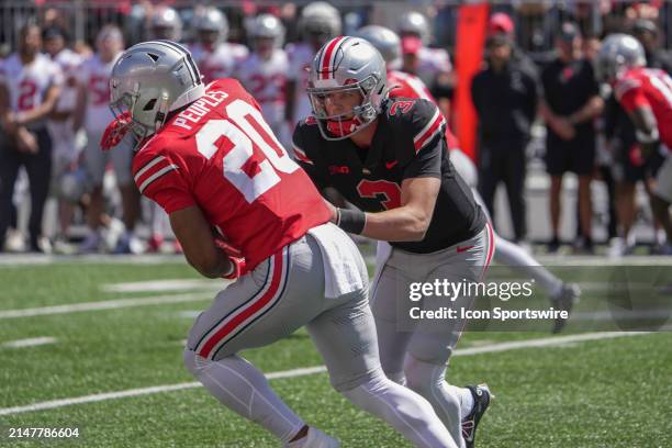 Ohio State Buckeyes quarterback Lincoln Kienholz hands the ball off to Ohio State Buckeyes running back James Peoples the Ohio State Spring Game at...