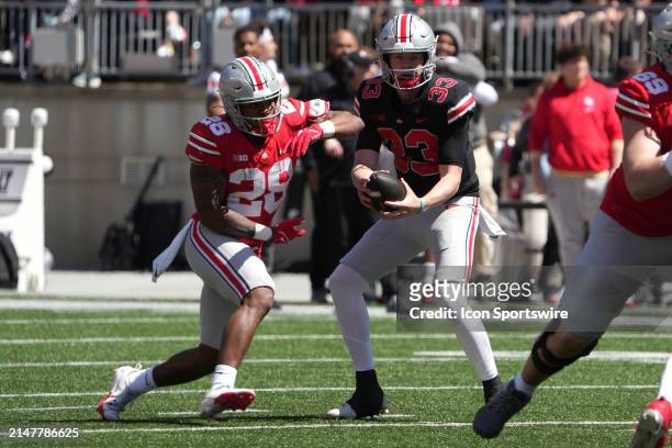 Ohio State Buckeyes quarterback Devin Brown hands off the ball to Ohio State Buckeyes running back TC Coffey during the Ohio State Spring Game at...