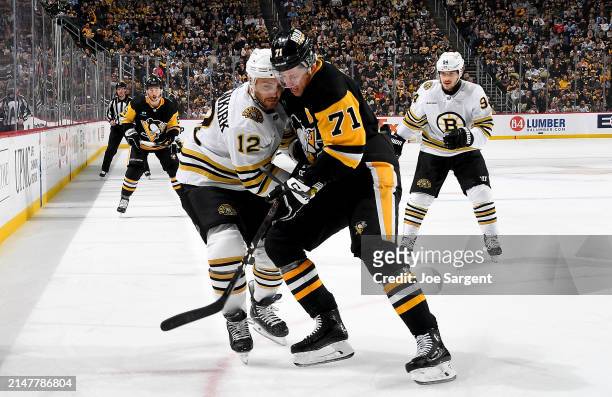 Evgeni Malkin of the Pittsburgh Penguins battles against Kevin Shattenkirk of the Boston Bruins at PPG PAINTS Arena on April 13, 2024 in Pittsburgh,...