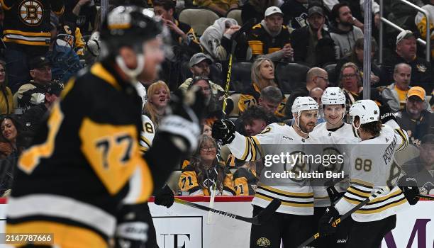 Kevin Shattenkirk of the Boston Bruins celebrates with Danton Heinen and David Pastrnak after scoring a goal in the second period during the game...