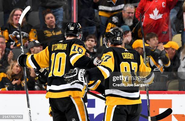 Bryan Rust of the Pittsburgh Penguins celebrates his second period goal against the Boston Bruins at PPG PAINTS Arena on April 13, 2024 in...