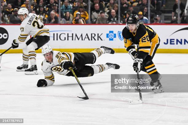 Pittsburgh Penguins center Lars Eller skates with the puck against Boston Bruins defenseman Brandon Carlo during the second period in the NHL game...