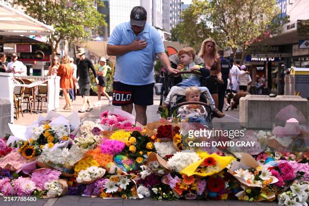 Man reacts after leaving flowers outside the Westfield Bondi Junction shopping mall in Sydney on April 14 the day after a 40-year-old knifeman with...