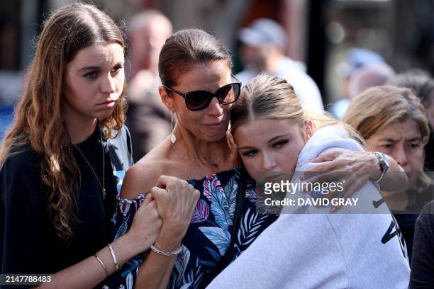 People react outside the Westfield Bondi Junction shopping mall in Sydney on April 14 the day after a 40-year-old knifeman with mental illness roamed...