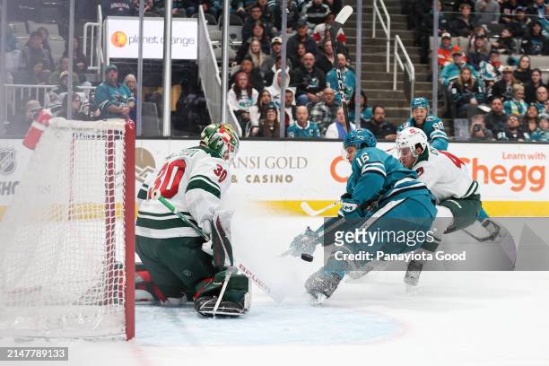 Jack Studnicka of the San Jose Sharks rushes toward the net in front of Marcus Foligno and Jesper Wallstedt of the Minnesota Wild during the first...