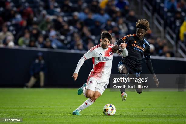 Carles Gil of New England Revolution battles against Malachi Jones of New York City in the second half of the Major League Soccer match at Yankee...